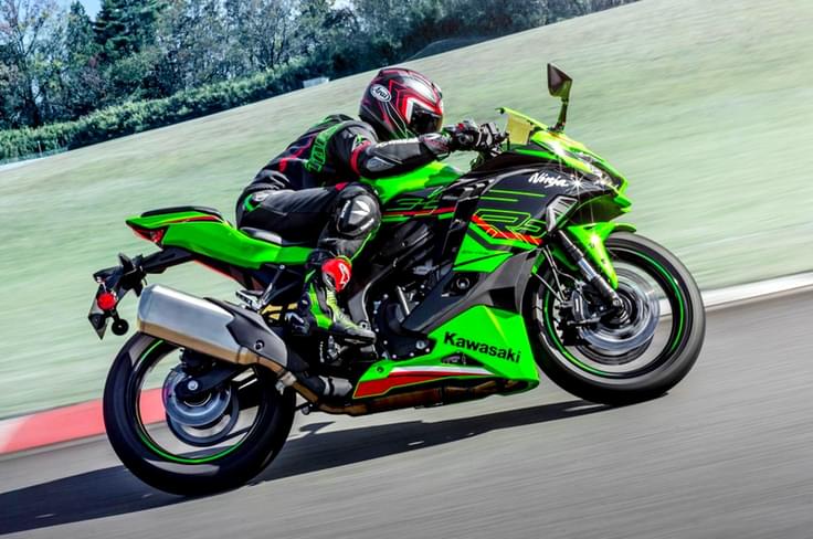 It is powered by a 399cc, 4-cyl motor making 80hp and 39Nm of torque Kawasaki Ninja ZX4RR right side profile riding image on track